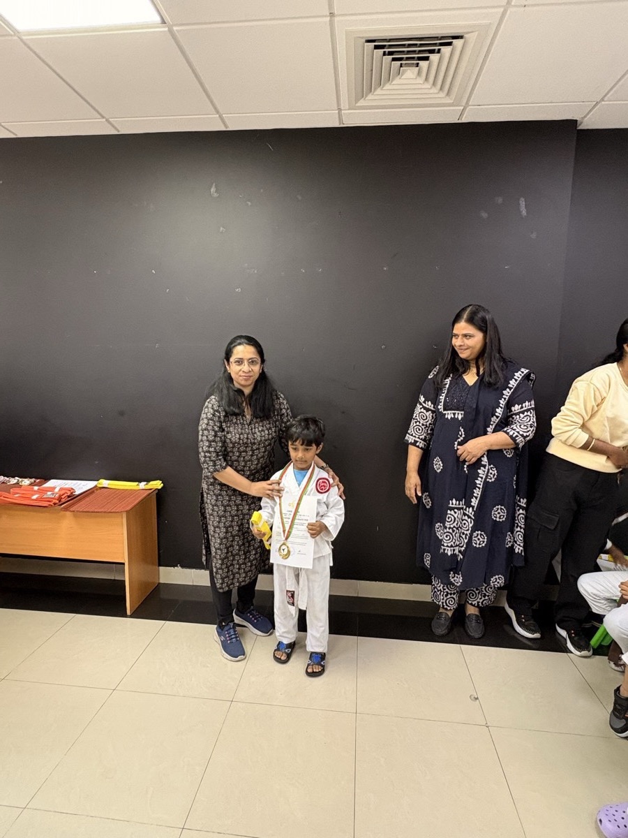 Dhyanchand in karate gi receiving his medal and certificate