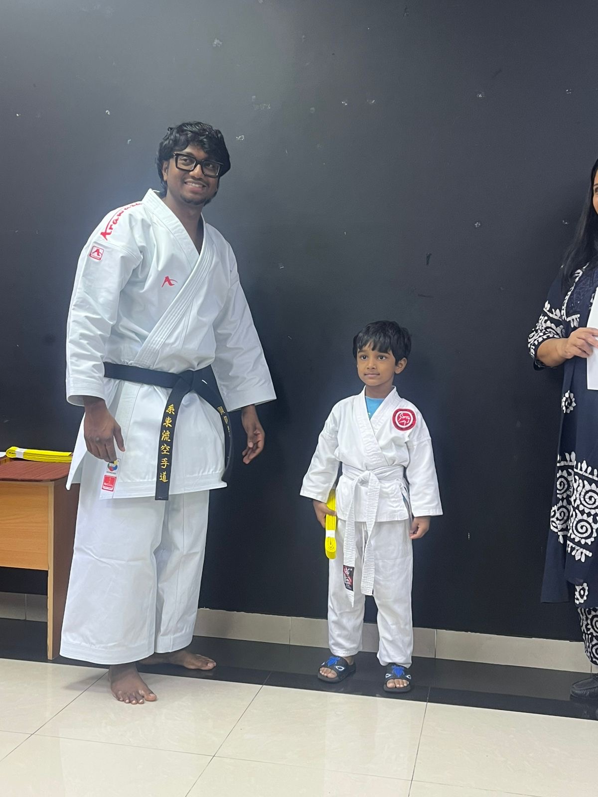 Dhyanchand standing with his Sensei in the dojo, both in karate uniforms